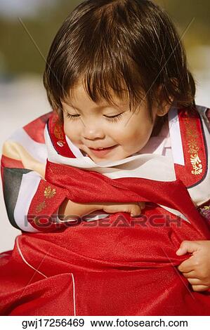 Close-up of a girl in traditional clothing smiling View Large Photo Image Stock Photo - Close-up of a girl in traditional clothing smiling. Fotosearch