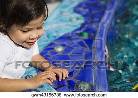 Stock Photo - Close-up of a girl leaning at the poolside. Fotosearch