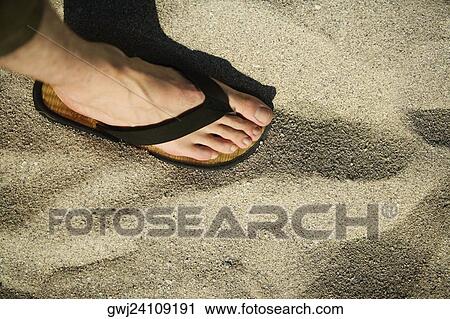 Stock Image - Close-up of a human foot wearing a sandal. Fotosearch