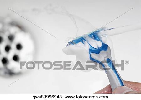 Close-up of a human hand washing a razor View Large Photo Image Stock Photo - Close-up of a human hand washing a razor. Fotosearch