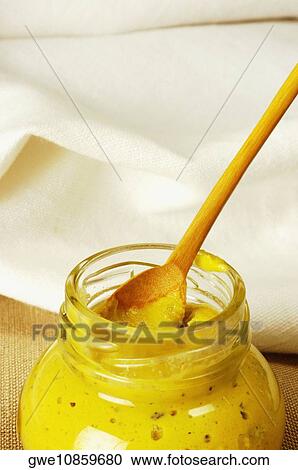 Close-up of a jar of mustard with a wooden spoon View Large Photo Image Stock Image - Close-up of a jar of mustard with a wooden spoon. Fotosearch