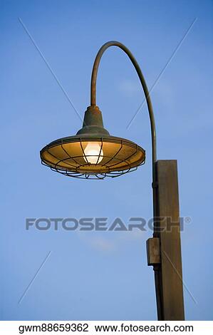 Close-up of a lamppost lit up at day View Large Photo Image Stock Image - Close-up of a lamppost lit up at day. Fotosearch