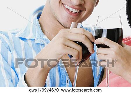 Close-up of a man and woman toasting with wine glasses View Large Photo Image Stock Image - Close-up of a man and woman toasting with wine glasses. Fotosearch