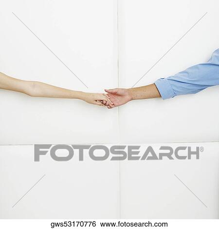 Close-up of a man holding a woman's hand View Large Photo Image Stock Photograph - Close-up of a man holding a woman's hand. Fotosearch