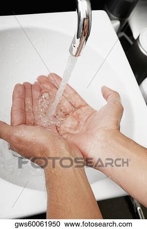 Close-up of a man washing his hands in the bathroom sink View Large Photo Image Stock Image - Close-up of a man washing his hands in the bathroom sink. Fotosearch