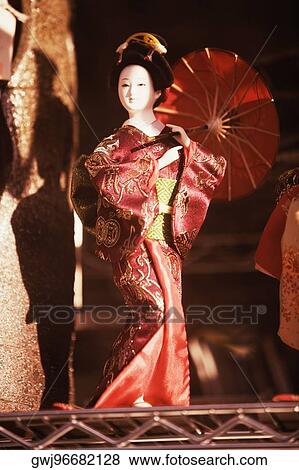 Close-up of a mannequin wearing a kimono and holding a parasol View Large Photo Image Stock Photo - Close-up of a mannequin wearing a kimono and holding a parasol. Fotosearch