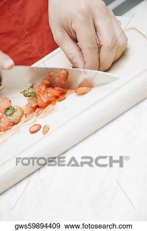Close-up of a man's hand cutting vegetables in the kitchen View Large Photo Image Stock Photo - Close-up of a man's hand cutting vegetables in the kitchen. Fotosearch