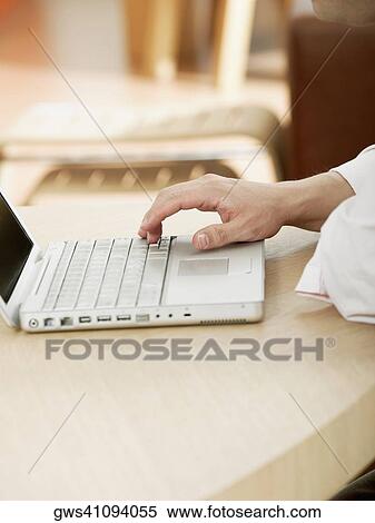 Close-up of a man's hand operating a laptop View Large Photo Image Stock Photography - Close-up of a man's hand operating a laptop. Fotosearch