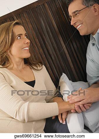 Close-up of a mature man and a mid adult woman looking at each other and smiling View Large Photo Image Picture - Close-up of a mature man and a mid adult woman looking at each other and smiling. Fotosearch