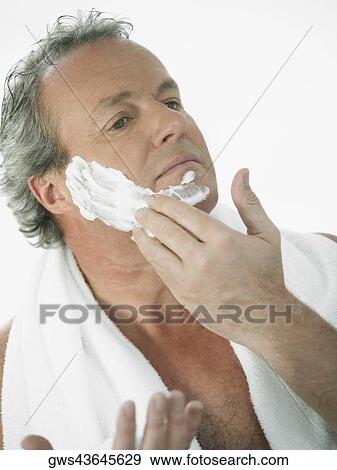 Close-up of a mature man applying shaving cream on his face View Large Photo Image Stock Photo - Close-up of a mature man applying shaving cream on his face. Fotosearch