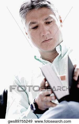 Close-up of a mature man holding a diary View Large Photo Image Stock Photo - Close-up of a mature man holding a diary. Fotosearch