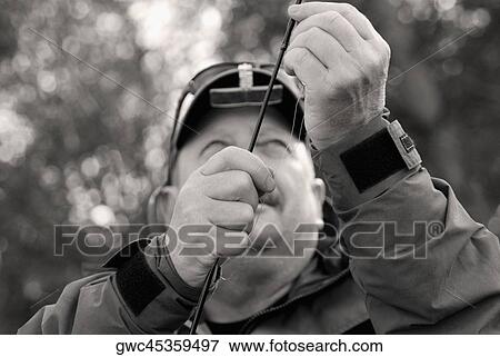 Close-up of a mature man holding a fishing rod View Large Photo Image Stock Photo - Close-up of a mature man holding a fishing rod. Fotosearch