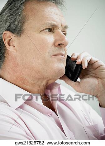 Close-up of a mature man holding on a mobile phone View Large Photo Image Stock Image - Close-up of a mature man holding on a mobile phone. Fotosearch