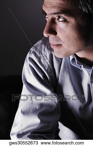 Stock Image - Close-up of a mature man looking sideways and thinking. Fotosearch