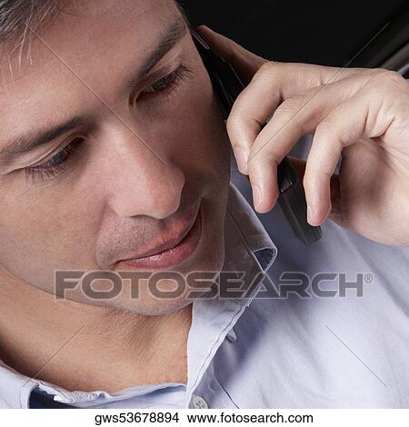 Close-up of a mature man talking on a mobile phone View Large Photo Image Picture - Close-up of a mature man talking on a mobile phone. Fotosearch
