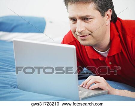 Close-up of a mature man using a laptop View Large Photo Image Stock Image - Close-up of a mature man using a laptop. Fotosearch