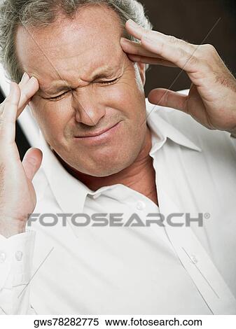 Stock Photography - Close-up of a mature man with his head in his hands. Fotosearch