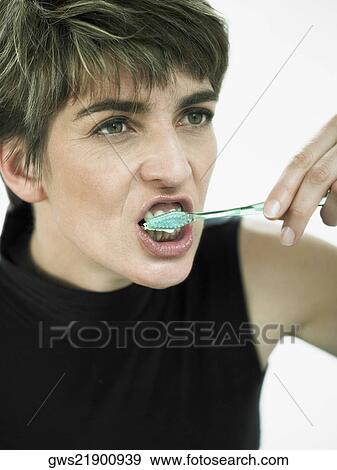 Close-up of a mature woman brushing her teeth View Large Photo Image Stock Photo - Close-up of a mature woman brushing her teeth. Fotosearch