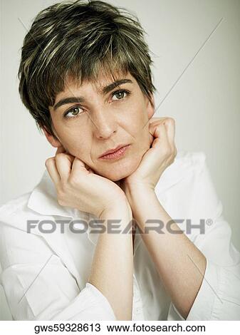 Close-up of a mature woman thinking View Large Photo Image Stock Image - Close-up of a mature woman thinking. Fotosearch