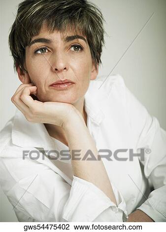 Close-up of a mature woman with her hand on her chin View Large Photo Image Stock Image - Close-up of a mature woman with her hand on her chin. Fotosearch