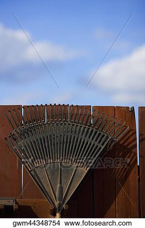 Picture - Close-up of a metal structure against a wooden fence. Fotosearch