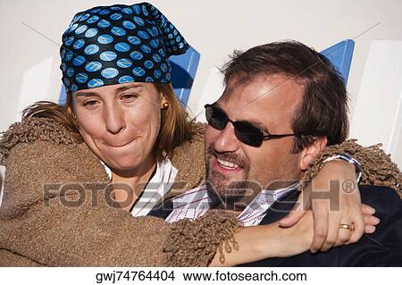 Close-up of a mid adult couple embracing each other View Large Photo Image Picture - Close-up of a mid adult couple embracing each other. Fotosearch