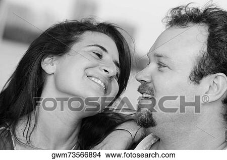Close-up of a mid adult couple smiling View Large Photo Image Picture - Close-up of a mid adult couple smiling. Fotosearch