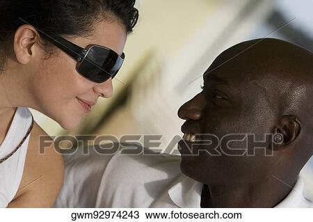 Stock Image - Close-up of a mid adult couple smiling. Fotosearch