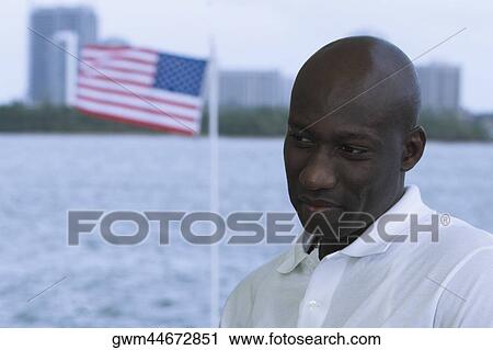 Stock Image - Close-up of a mid adult man grinning. Fotosearch