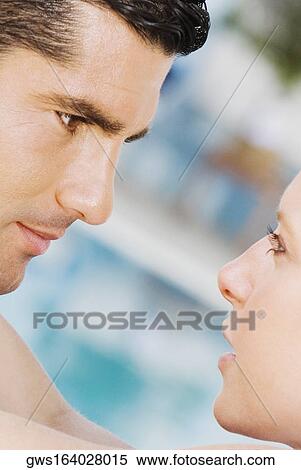 Close-up of a mid adult man looking at a mid adult woman View Large Photo Image Stock Photography - Close-up of a mid adult man looking at a mid adult woman. Fotosearch