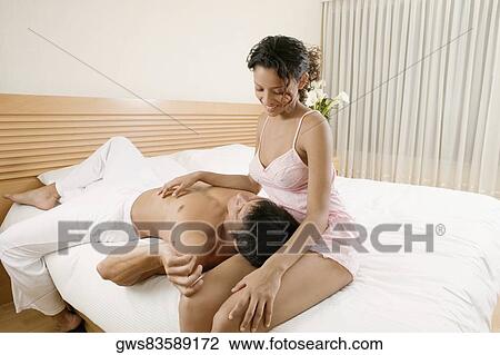 Close-up of a mid adult man lying on a teenage girl's lap and smiling View Large Photo Image Stock Image - Close-up of a mid adult man lying on a teenage girl's lap and smiling. Fotosearch