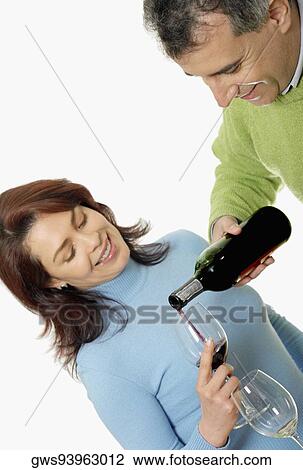 Close-up of a mid adult man pouring wine into a mid adult woman's glass View Large Photo Image Stock Image - Close-up of a mid adult man pouring wine into a mid adult woman's glass. Fotosearch
