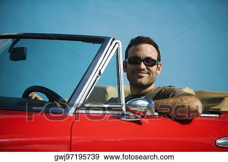 Close-up of a mid adult man sitting in a convertible car, Miami, Florida, USA View Large Photo Image Stock Photo - Close-up of a mid adult man sitting in a convertible car, Miami, Florida, USA. Fotosearch