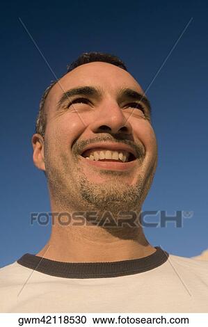 Close-up of a mid adult man smiling View Large Photo Image Stock Image - Close-up of a mid adult man smiling. Fotosearch