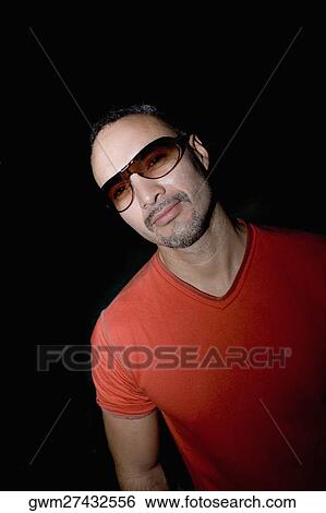 Close-up of a mid adult man wearing sunglasses View Large Photo Image Stock Photograph - Close-up of a mid adult man wearing sunglasses. Fotosearch