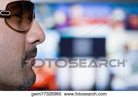 Close-up of a mid adult man wearing sunglasses View Large Photo Image Stock Photography - Close-up of a mid adult man wearing sunglasses. Fotosearch