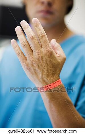 Close-up of a mid adult man's hand with dosage tag around his wrist View Large Photo Image Stock Image - Close-up of a mid adult man's hand with dosage tag around his wrist. Fotosearch