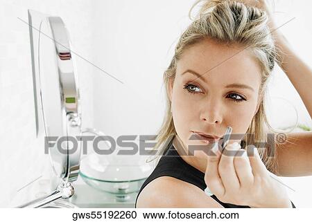 Close-up of a mid adult woman holding a pair of eyebrow tweezers View Large Photo Image Stock Image - Close-up of a mid adult woman holding a pair of eyebrow tweezers. Fotosearch