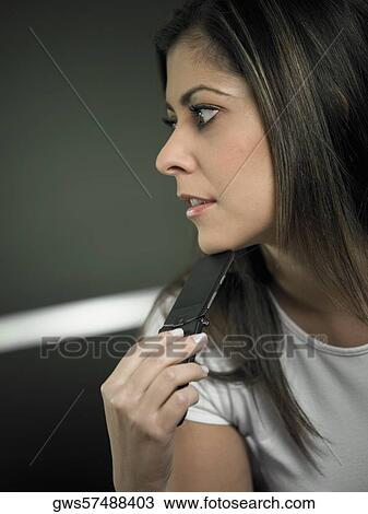 Close-up of a mid adult woman holding a mobile phone View Large Photo Image Stock Image - Close-up of a mid adult woman holding a mobile phone. Fotosearch