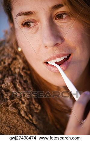 Picture - Close-up of a mid adult woman looking sideways. Fotosearch