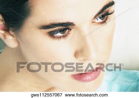 Stock Photo - Close-up of a mid adult woman looking away. Fotosearch