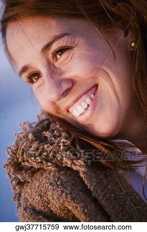 Stock Photo - Close-up of a mid adult woman smiling. Fotosearch