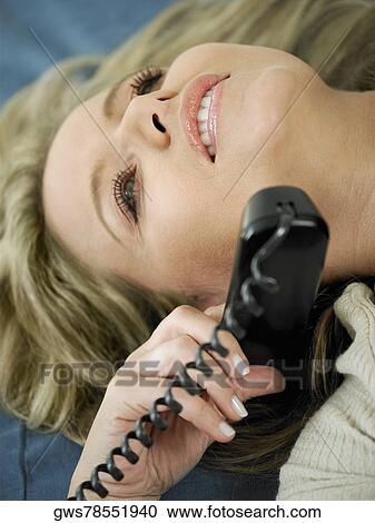 Close-up of a mid adult woman talking on the telephone View Large Photo Image Stock Image - Close-up of a mid adult woman talking on the telephone. Fotosearch