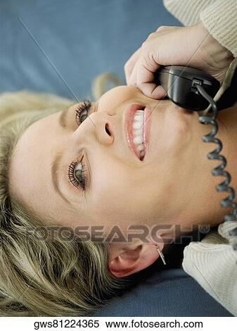 Close-up of a mid adult woman talking on the telephone View Large Photo Image Stock Photography - Close-up of a mid adult woman talking on the telephone. Fotosearch