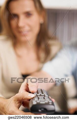 Close-up of a mid adult woman using a remote control View Large Photo Image Stock Photo - Close-up of a mid adult woman using a remote control. Fotosearch