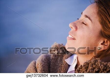 Close-up of a mid adult woman with her eyes closed View Large Photo Image Picture - Close-up of a mid adult woman with her eyes closed. Fotosearch