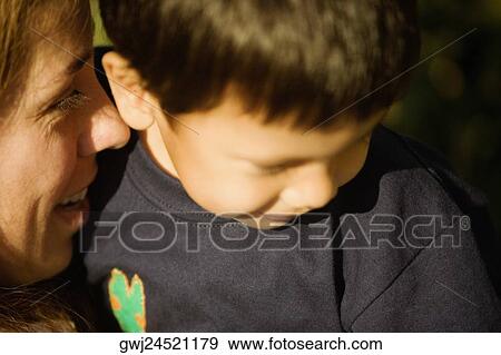 Stock Photo - Close-up of a mid adult woman with her son. Fotosearch