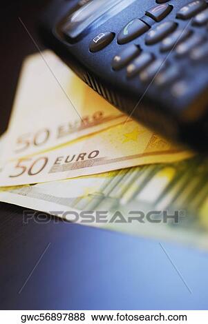 Close-up of a mobile phone on fifty Euro banknotes View Large Photo Image Stock Photo - Close-up of a mobile phone on fifty Euro banknotes. Fotosearch
