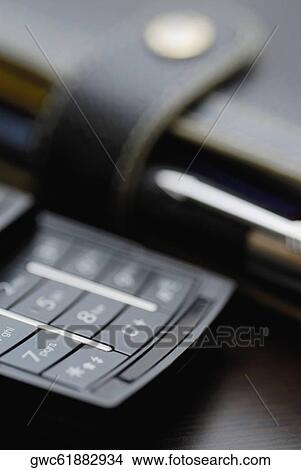 Picture - Close-up of a mobile phone with a diary. Fotosearch