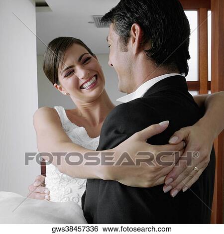 Close-up of a newlywed couple embracing each other and smiling View Large Photo Image Stock Photograph - Close-up of a newlywed couple embracing each other and smiling. Fotosearch